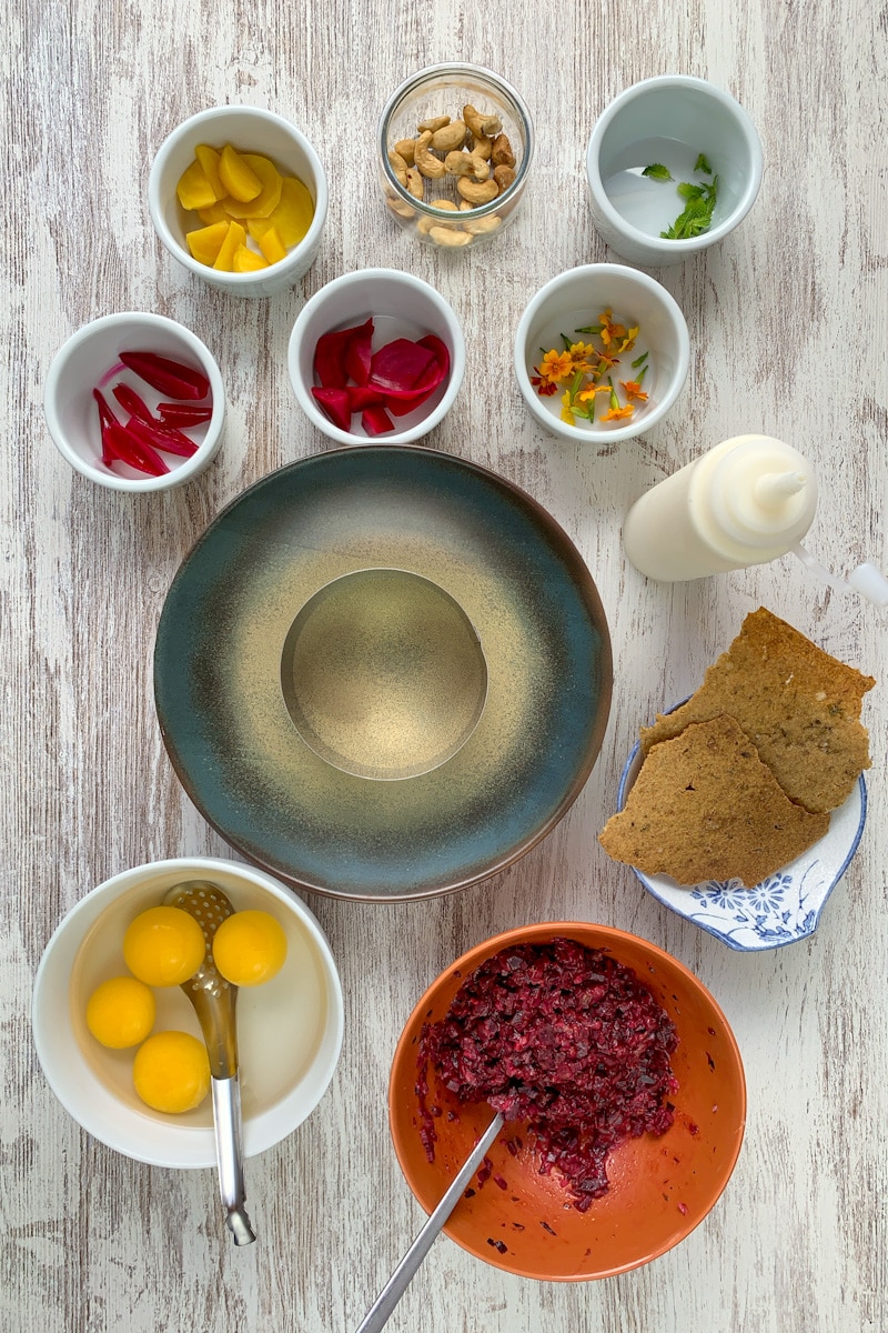 A vegetarian tartare with beetroot, fake egg yolk and sourdough crackers